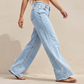 Högmidjade jeans med vida ben och slitna kanter