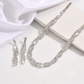 Set med halsband och örhängen med glittrande strass och klorformad kedja för kvinnor