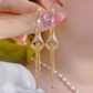 Eleganta geometriska örhängen med tofsar